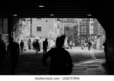 Silhouettes of people going out of the subway in London