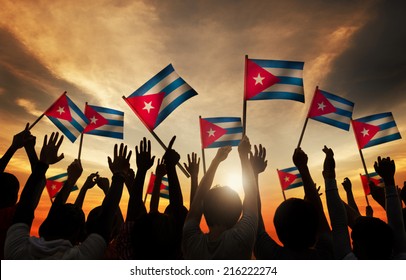 Silhouettes Of People Holding Flag Of Cuba