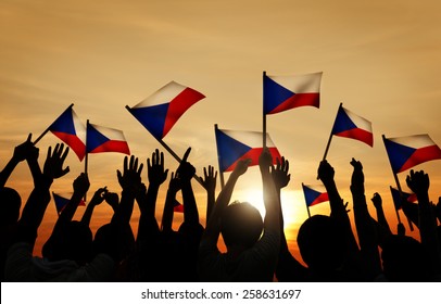 Silhouettes Of People Holding The Flag Of Philippines Concept