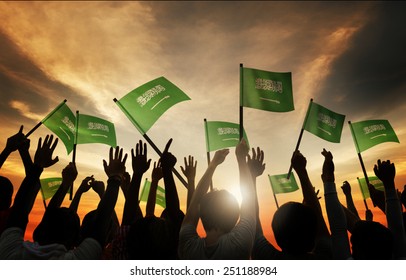 Silhouettes Of People Holding Flag Of Saudi Arabia