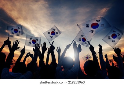 Silhouettes Of People Holding Flag Of South Korea