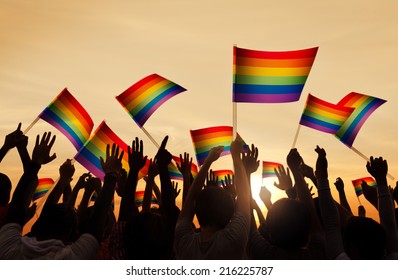 Silhouettes Of People Holding Gay Pride Symbol FLag