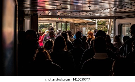 Silhouettes Of People Leaving The Dark Ferry To The Light