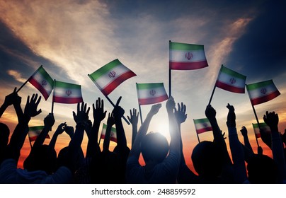Silhouettes Of People Waving The Flag Of Iran
