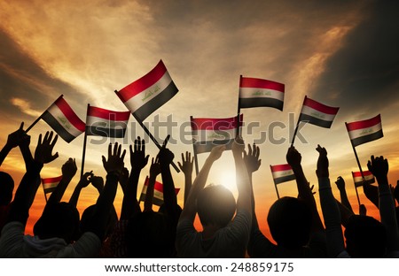 Silhouettes of People Waving the Flag of Iraq