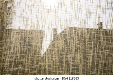 Silhouettes of rooftops through canvas as background