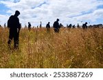 Silhouettes of soldiers at a D-Day landing memorial in Normandy