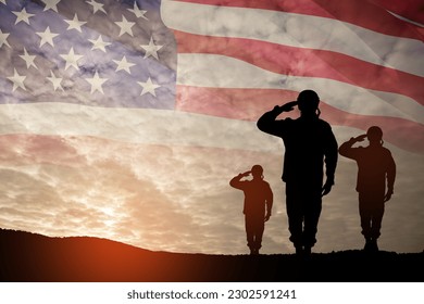 Silhouettes of soldiers saluting on background of sunset or sunrise and USA flag. Greeting card for Veterans Day, Memorial Day, Independence Day. America celebration. - Shutterstock ID 2302591241