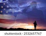 Silhouettes of a soldiers with USA flag against the sunset. Veterans Day, Memorial Day concept