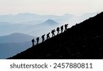 silhouettes of the team climbing the summit mountains