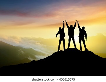 Silhouettes of team on mountain peak. Sport and active life concept - Shutterstock ID 403615675