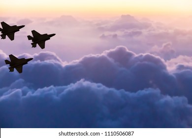 Silhouettes of three F-35 aircraft on sunset sky background