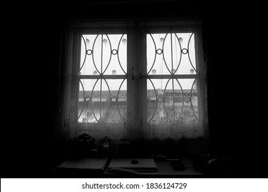 Silhouettes through the window frames against the backdrop of decorative curtains