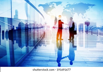 Silhouettes of Two Businessman Shaking Hands