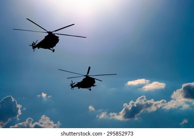 Silhouettes Of Two Helicopters Flying