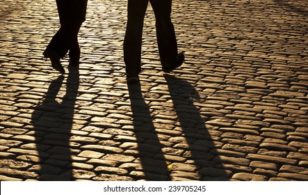 Silhouettes Of Two Men Walking