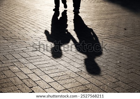 Similar – Image, Stock Photo Shadow of two people on a colorful house facade with window, one person holds a cell phone in his hand