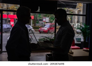 Silhouettes Of Two Senior Businessmen Working Together While Talking In The Office, Silhouette Shot