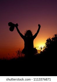 Silhouettes women and boxing gloves in their hands  A girl boxer in dress  Athlete and arms raised  Victory  fights  joy  Sunset  Champion  winner 