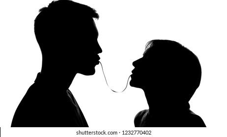 Silhouettes Of Young People Eating Spaghetti On Date, Lovers Cooking Together