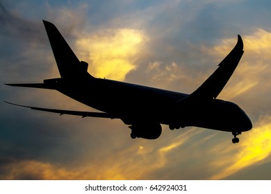 Silhoutte Of An Airplane In Dramatic Sunset Sky, Starboard Side View