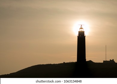 Silhoutte of the lighthouse of Texel by sunrise