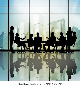 Silhouttes Of Business People As Team Sitting Round Table