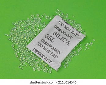 Silica Gel Desiccant Beads Against Green Background