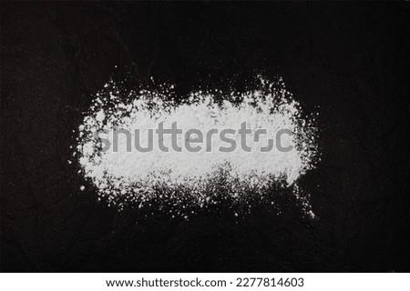 Silicon dioxide powder or Silica. Food additive E551,  anti-caking agent. Silicon oxide. White chemical dust scattered on dark surface. Stock foto © 