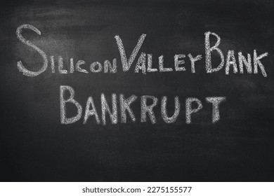 Silicon Valley Bank bankruptcy written in white chalk on a black board. A close-up. A place to insert text. Bankruptcy of an American bank. Financial crisis. Krasnodar, Russia March 14, 2023 - Shutterstock ID 2275155577