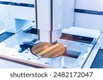 Silicon wafer with semiconductor microchip on machine process examining testing in microscope.