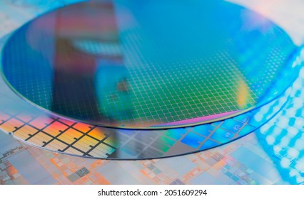 Silicon Wafers with microchips used in electronics for the fabrication of integrated circuits - Shutterstock ID 2051609294