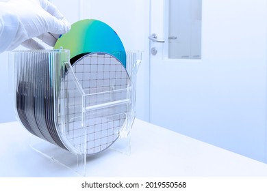 Silicon Wafers In Storage Box On Table In Clear Room Prepared For Production Of Semiconductor Foundry.