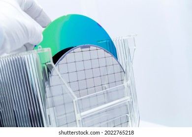 Silicon Wafers In Storage Box On Table In Clear Room Prepared For Production Of Semiconductor Foundry.