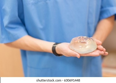 Silicone Breast Implant. Doctor Hold Silicone Breast Prosthesis