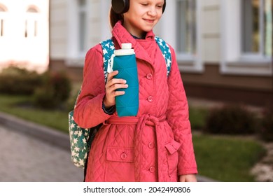 Silicone Reusable Water Bottle In Hands Of Little School Girl 