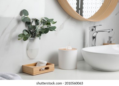 Silicone Vase With Eucalyptus Branches On White Marble Wall Over Countertop In Stylish Bathroom