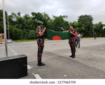 Siliguri, West Bengal India- July 08 2022: Bangladeshi national guard holding national flag. Flag hoisting ceremony organized at the India Bangladesh border.