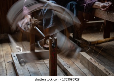 Silk Being Spun Into Thread On Traditional Wooden Spinning Wheel. Fast Spinning Wheel, Motion Blur Action