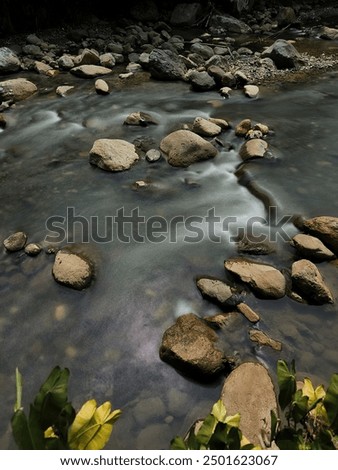 Silk effect water flows between the rocks in the  shallow river. Concept of dynamic in nature 