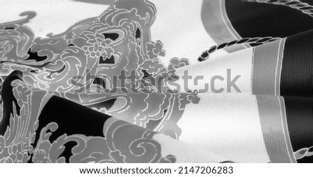 Silk fabric in black, white and gray colors. Heraldic shield with angel wings and ribbons for medieval design - Print on canvas. Texture background pattern.