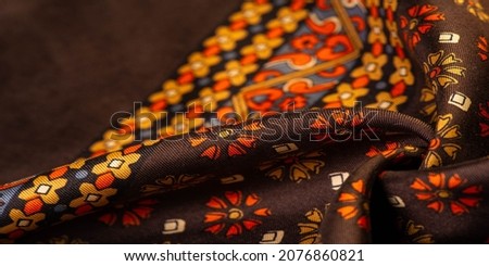 silk fabric of brown color with red and yellow colors, dense fabric, double-sided based on triacetate fibers. Texture, Background, Pattern,