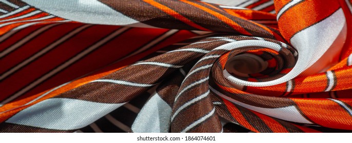 silk fabric with a red-brown pattern with white stripes. Poncho with Mexican motives. texture, background