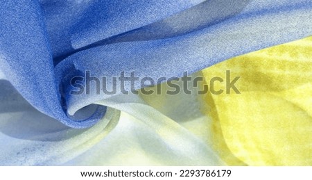 silk fabric in soft blue, yellow and white tones with abstract patterns and bed tones. Texture, pattern, collection