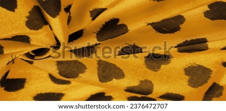 silk fabric in yellow. print of black hearts, texture background, pattern, postcard