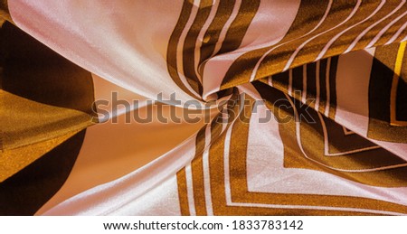 silk fabric with yellow striped pattern. Poncho with Mexican motives. texture, background