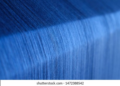 ฺBlue silk on a warping loom of a textile mill, Silk for weaving on a hand loom, Hand Made Silk Process, Close up macro detail of Yarn thread lines running in the weaving loom machine.  - Shutterstock ID 1472388542