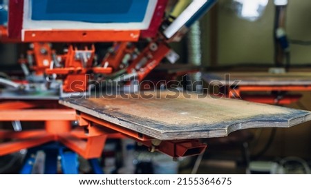 silk screen printing. selective focus photo. serigraphy production. empty wooden shelve of the print screening apparatus