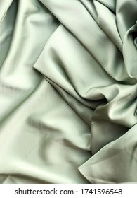 Silk Texture Of A Cloth. Mint Green Colored Fabric Material. Closeup.