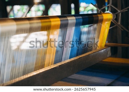 Silk thread from weaving machine traditional craft, a vibrant tapestry of color.